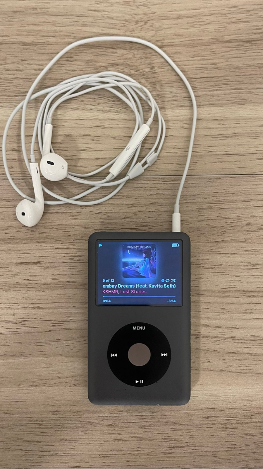 iPod Classic 7th gen running Rockbox with Apple wired earbuds plugged in