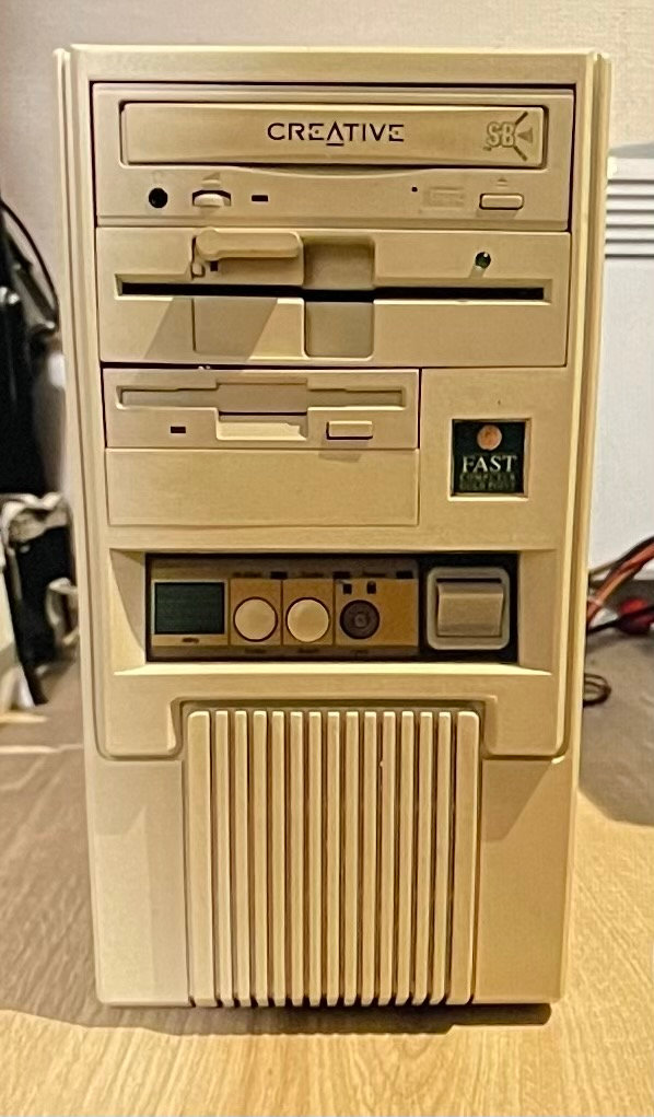 Beige DOS-era tower PC with turbo button, floppy drives, and Creative Sound Blaster CD-ROM drive